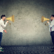 two people yelling at eachother via megaphones