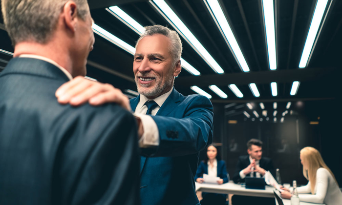 Business leader touching other man's shoulder